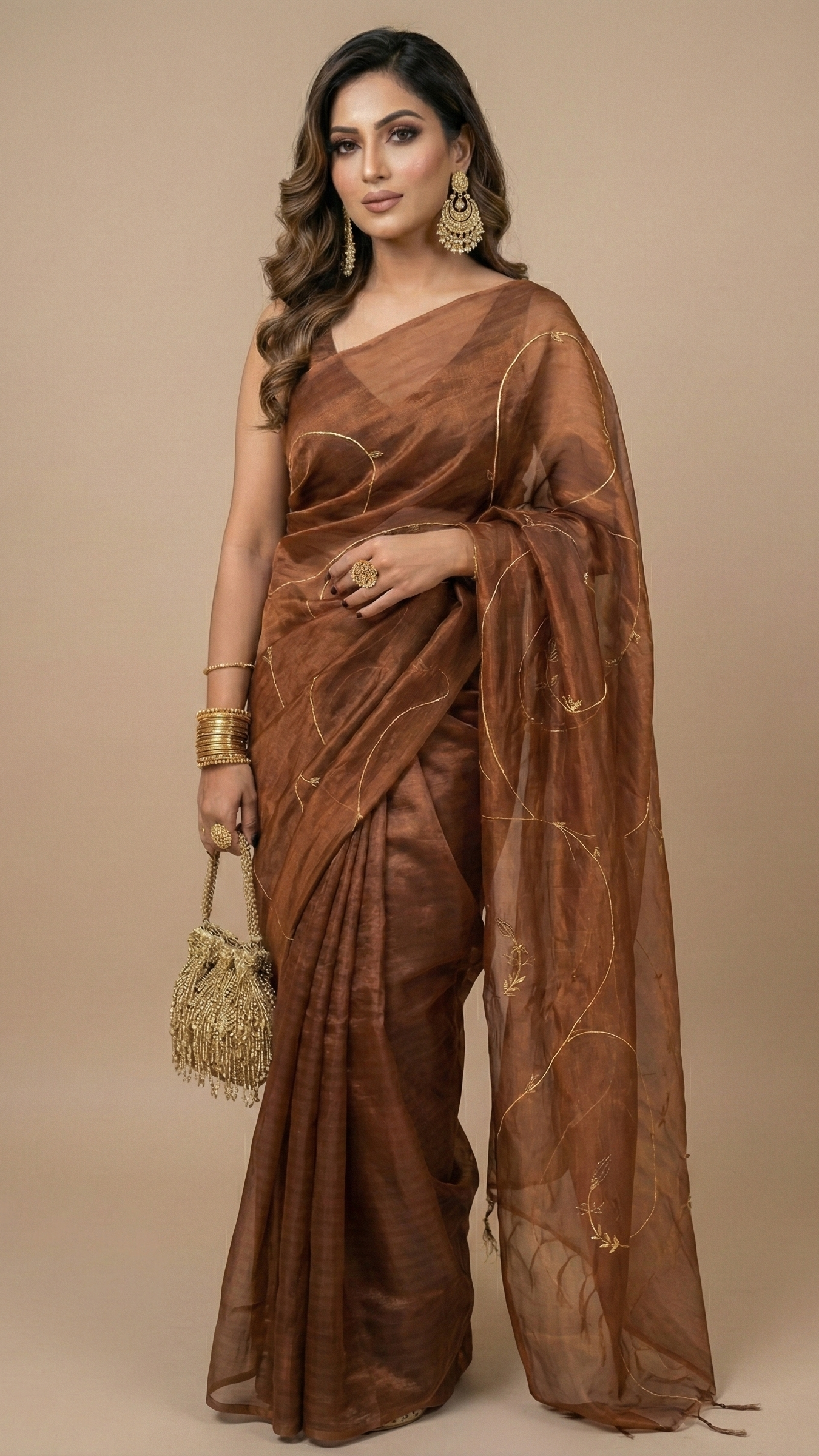 Woman wearing a brown saree with gold accents on a beige background