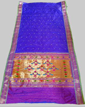 Blue and purple saree with intricate patterns on a white background