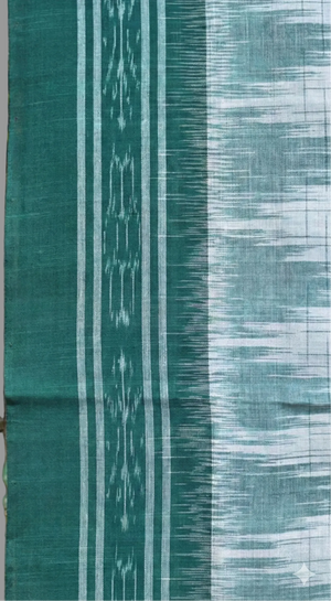 Textile with green and blue patterned fabric next to decorative animal figurines.