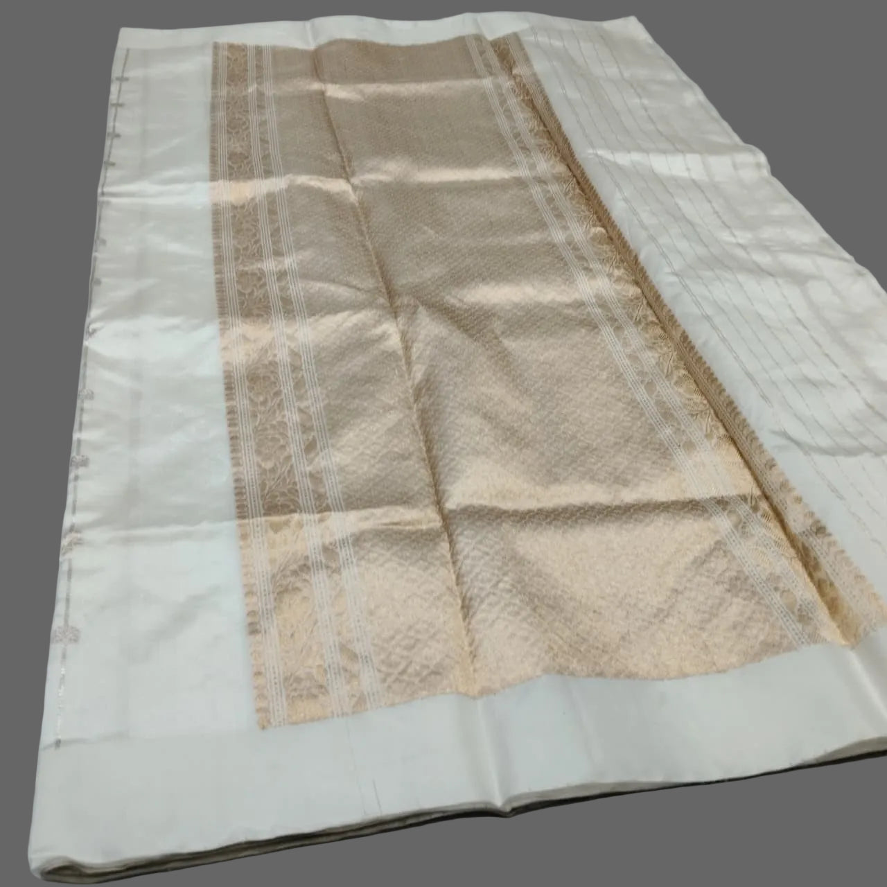 Folded fabric with beige and white pattern on a white background